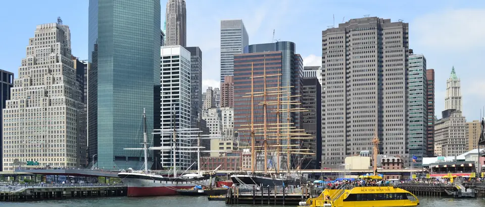 Lower Manhattan towers above the East River waterfront at South Street