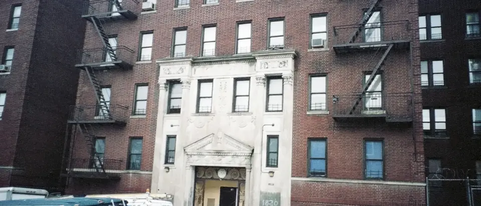 A brick apartment building with fire escapes on Loring Place South in the Bronx