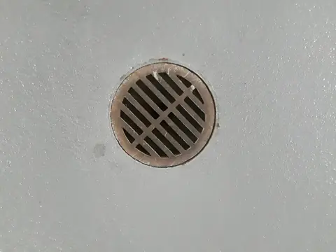 A round drain set in a concrete floor