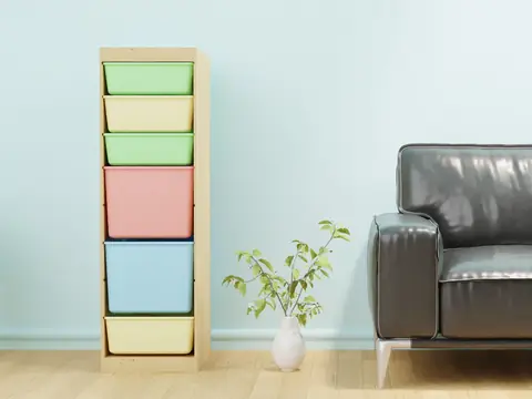 A stack of plastic storage drawers standing in a bright room