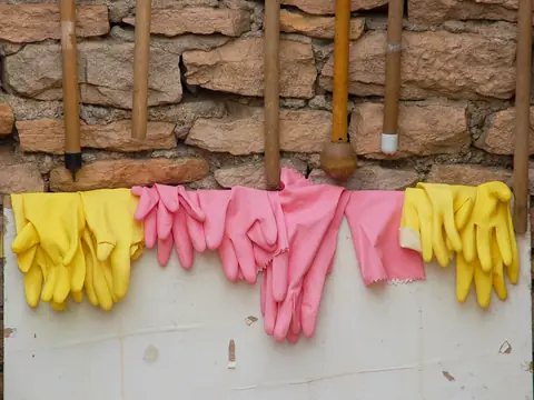 Rubber gloves hung up to dry along a wall